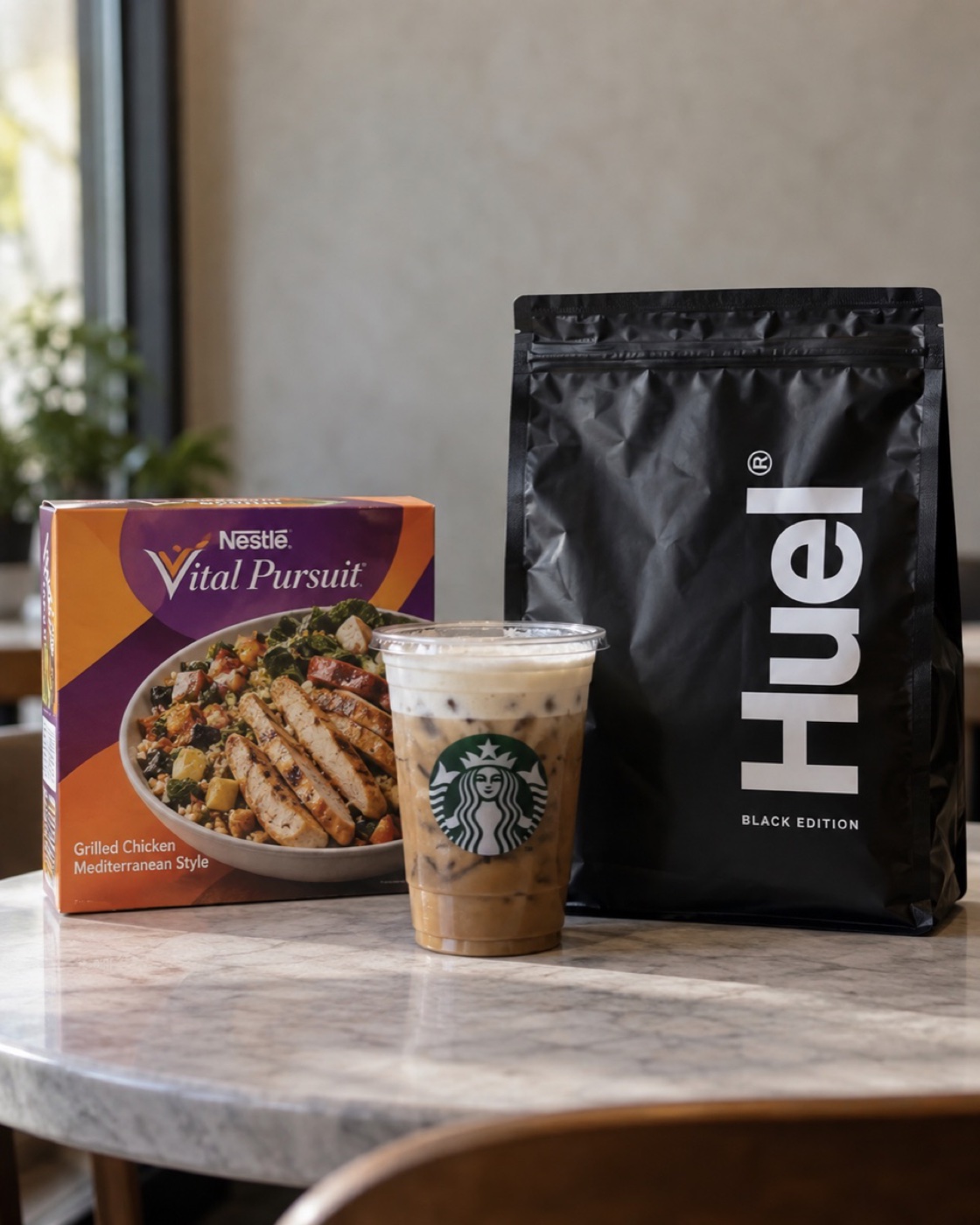 A Nestlé Vital Pursuit meal, a Starbucks cup and a bag of Huel