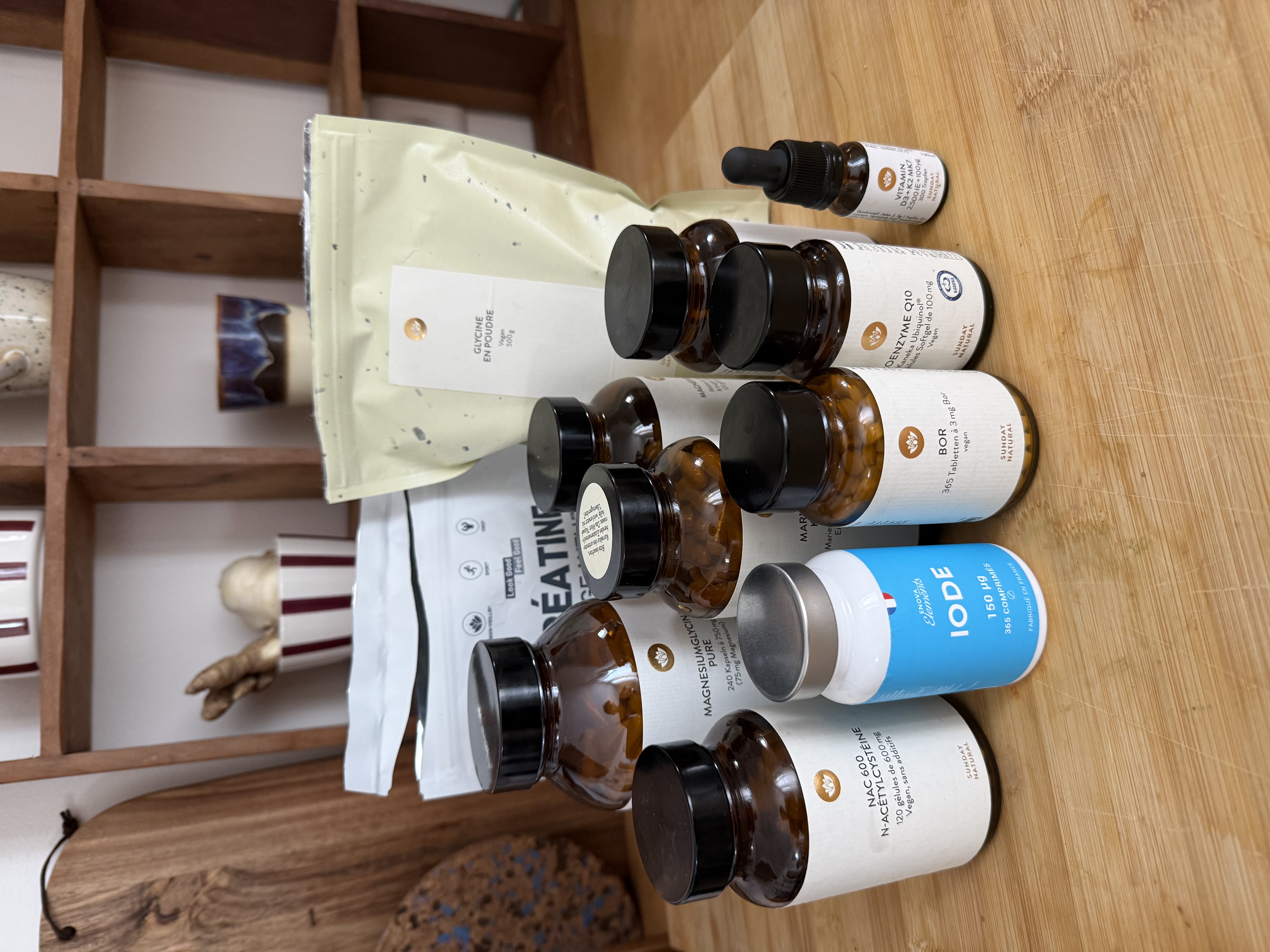 My full supplement stack — bottles of Sunday Natural, creatine, glycine, and iodine on a kitchen counter
